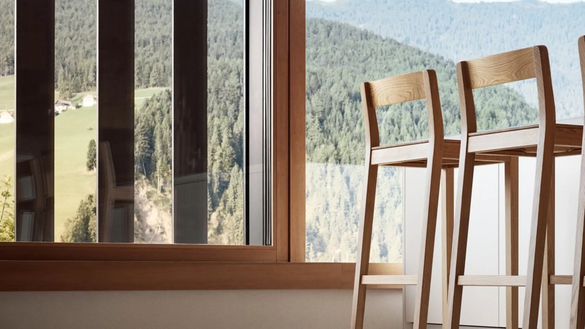 Tall wooden chairs beside a glazed wall Tall wooden chairs beside a glazed wall