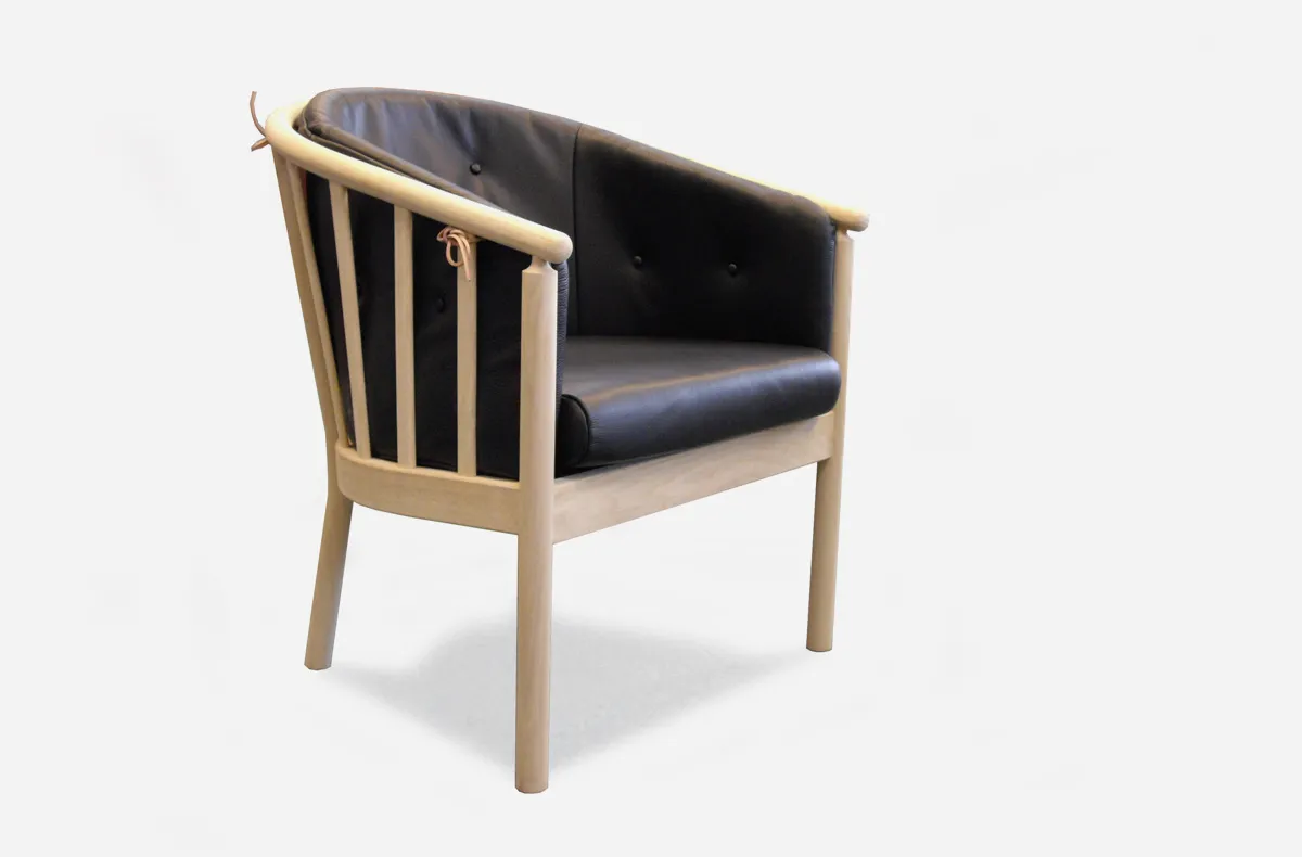 Wooden armchair with a black seat cushion Wooden armchair with a black seat cushion