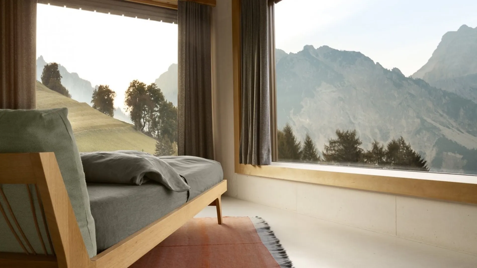 Seating area beside a window overlooking mountains Seating area beside a window overlooking mountains